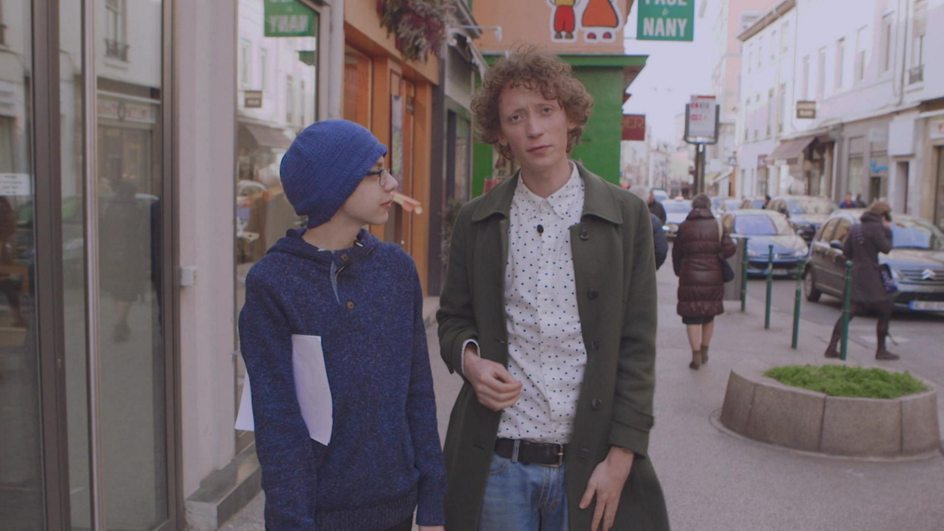 Ein junger Mann und ein Junge laufen gemeinsam durch eine Stadt.