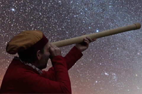 Ein Mann beobachtet Nachthimmel durch ein Fernrohr.