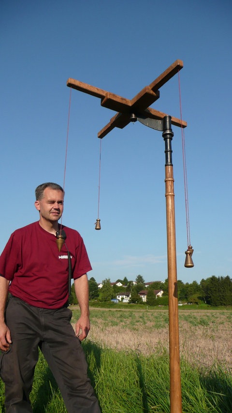 Ein Mann vermisst Gelände mit einer römischen Groma.