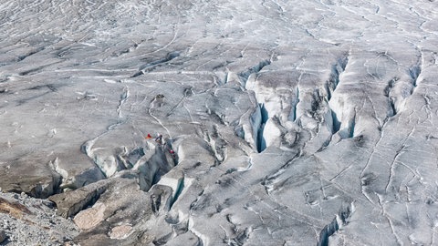 Gletscherspalten auf dem Rhonegletscher in der Schweiz. Die tiefen Risse im Eis des Gletschers sind gefährlich für den Menschen.