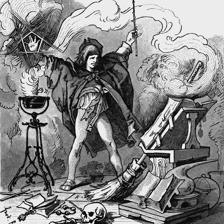 Schwarzweiß-Stich: Der Zauberlehrling in der Mitte des Bilds hebt beide Arme und hat einen Zauberstab in der Hand. Er ist umgeben von Rauch, vor ihm liegt ein großes aufgeschlagenes Buch auf einem Ständer, der Besen lehnt daran. (Foto: S.Barth: Goethe's)