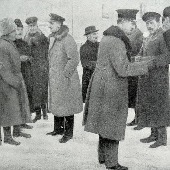 Mehrere Männer stehen in Uniform-Mänteln und Hüten umeinander und unterhalten sich (Foto: Imago, United Archives International)