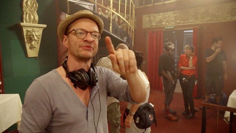 Jan Peter mit Kopfhörer um den Hals am Set.