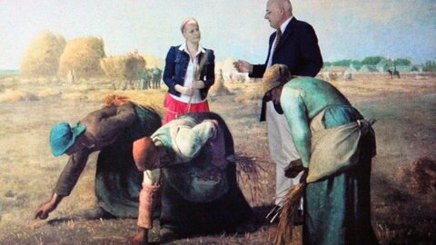 Enie van de Meiklokjes und Prof. Raimund Wünsche stehen im Bild „Die Ährenleserinnen“ von Jean-Francois Millet.