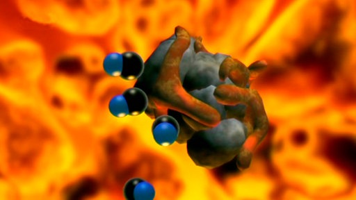 Trickaufnahme: Eisenerzstück, an dem paarweise blaue und schwarze Teilchen haften.