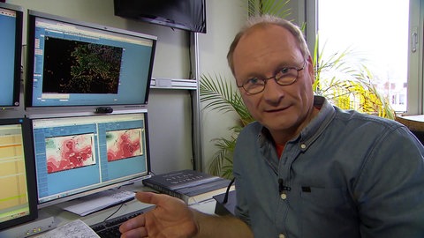 Sven Plöger vor Bildschirmen.