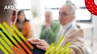 Eine Frau legt zuversichtlich ihre Hand auf die Schulter eines Mannes. 