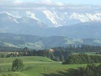 Das Emmental: Grüne Wiesen und hohe Berge am Horizont