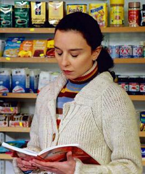 Eine Frau liest in einem Lebensmittelgeschäft eine Zeitschrift. (Foto: BR: DEUTSCH KLASSE)
