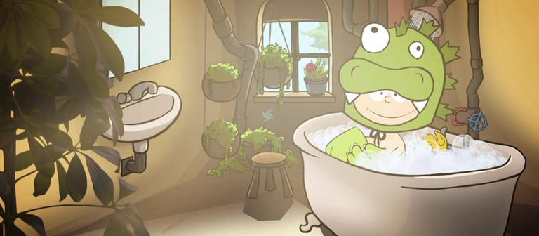 Der kleine Philosoph Knietzsche sitzt in einem grünen Monsterkostüm in einer vollen Badewanne. (Foto: vision X/WDR)